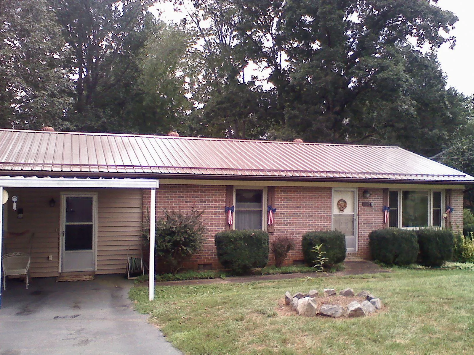 Bronze metal roof and carport on a brick ranch home — Roof Repair work by our crew in Prospect Hill
