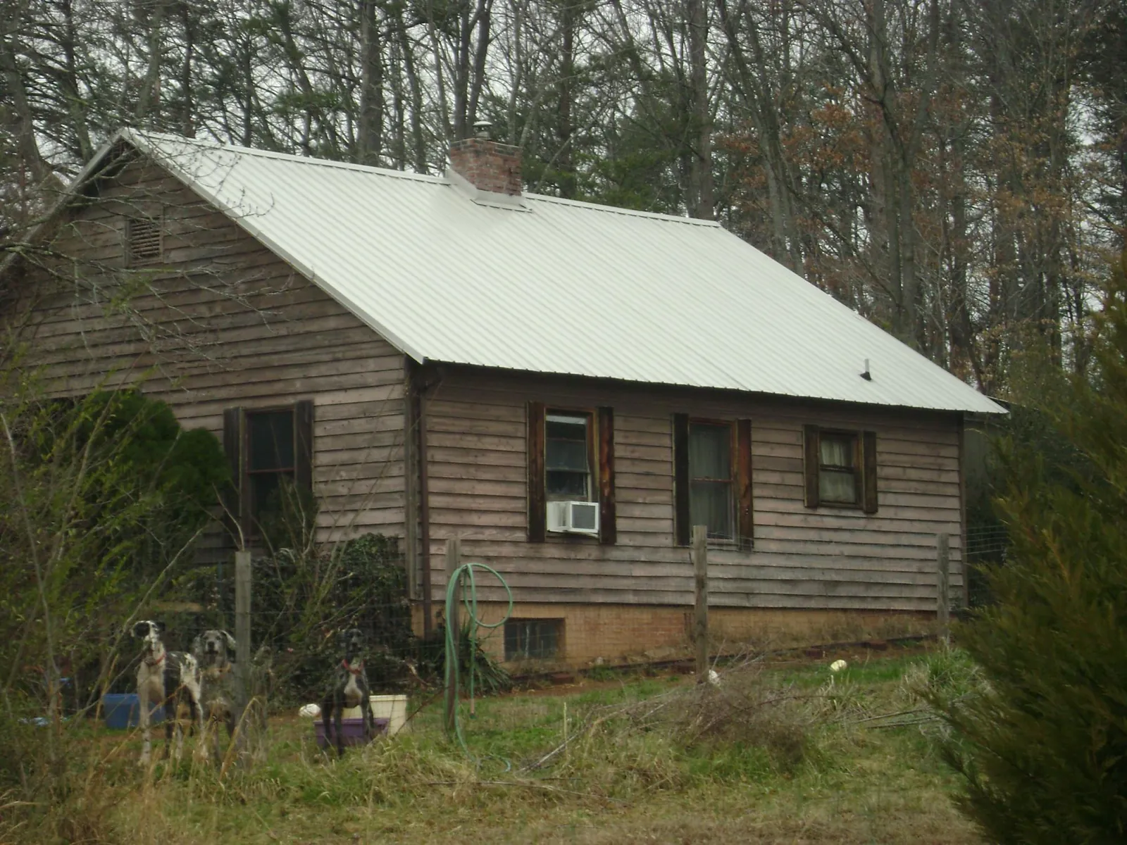 White metal roof on an old wood sided farmhouse, from a Metal Roof Installation job in Prospect Hill